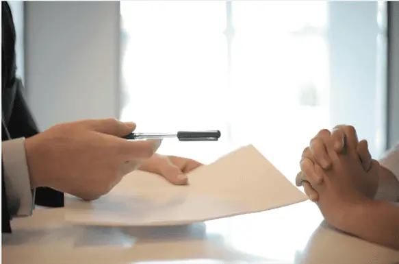 businessman giving contract to woman to sign