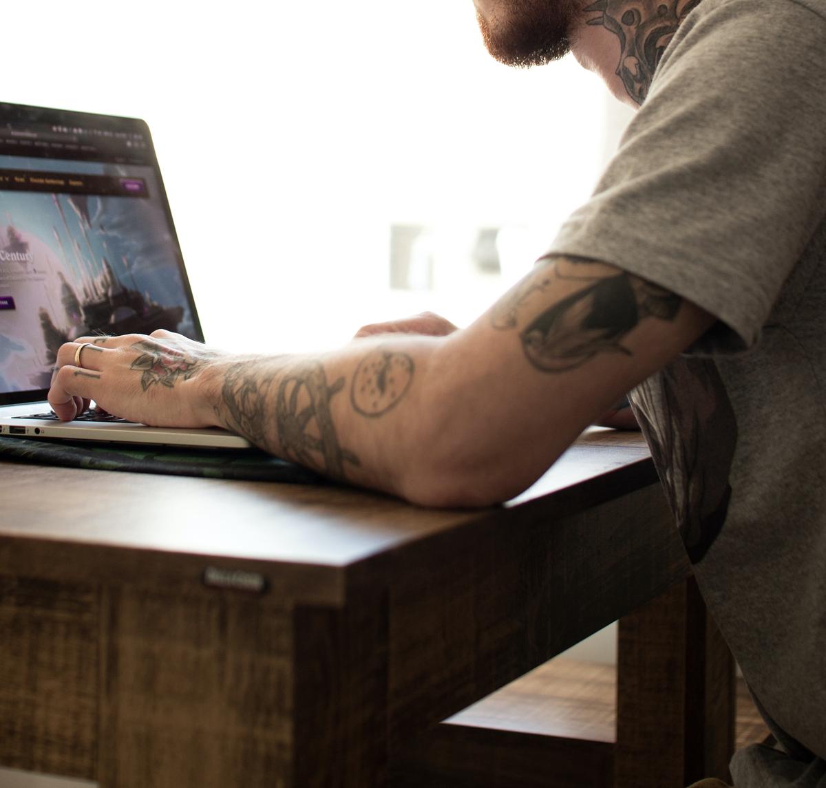 A Dell laptop specifically designed for gaming, showing a person playing a video game on the screen.